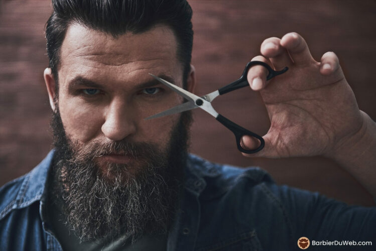 Bearded man holding scissors